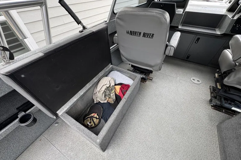 Slide: The Image of 2016 North River 21' Seahawk boat interior with open storage compartment and seating. - 24