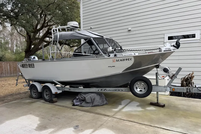 Slide: The Image of 2016 North River 21' Seahawk boat on trailer, parked beside a house. - 26