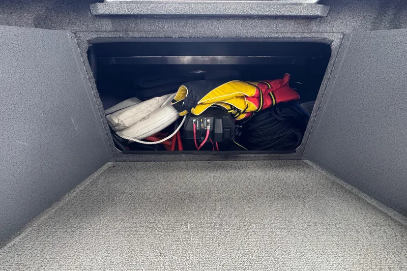 Slide: The Image of Storage compartment in a 2016 North River 21' Seahawk boat with life jackets and equipment. - 29
