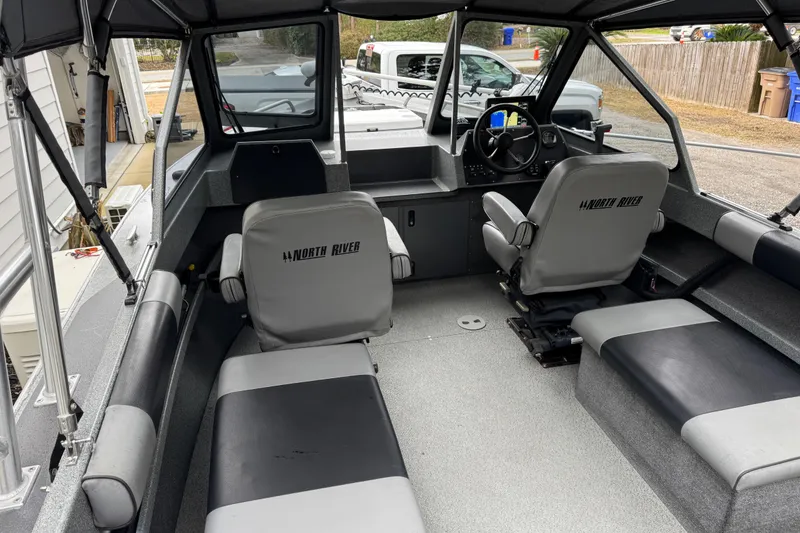 Slide: The Image of 2016 North River 21' Seahawk boat interior with seating and steering console. - 30