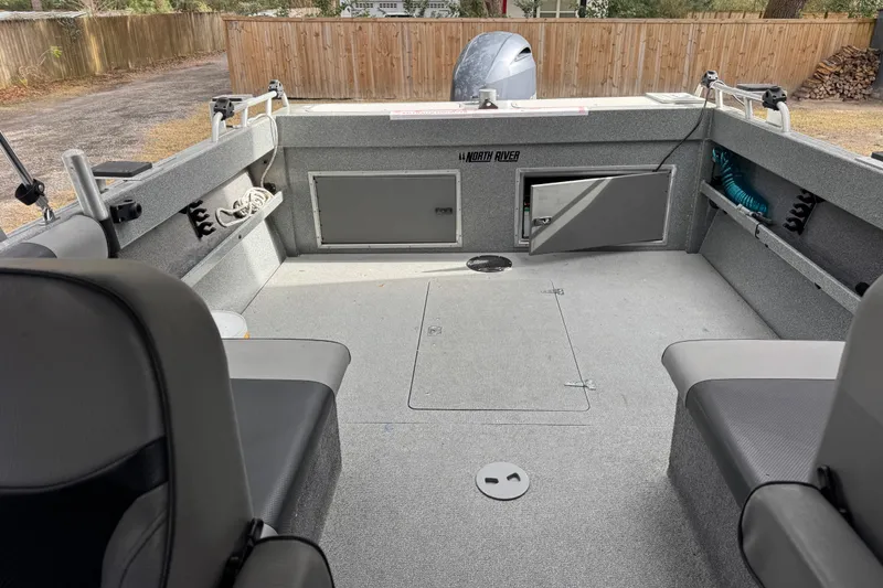 Slide: The Image of 2016 North River 21' Seahawk boat interior with open storage compartments and seating. - 32