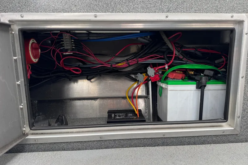 Slide: The Image of 2016 North River 21' Seahawk battery compartment with wiring and electrical components. - 40