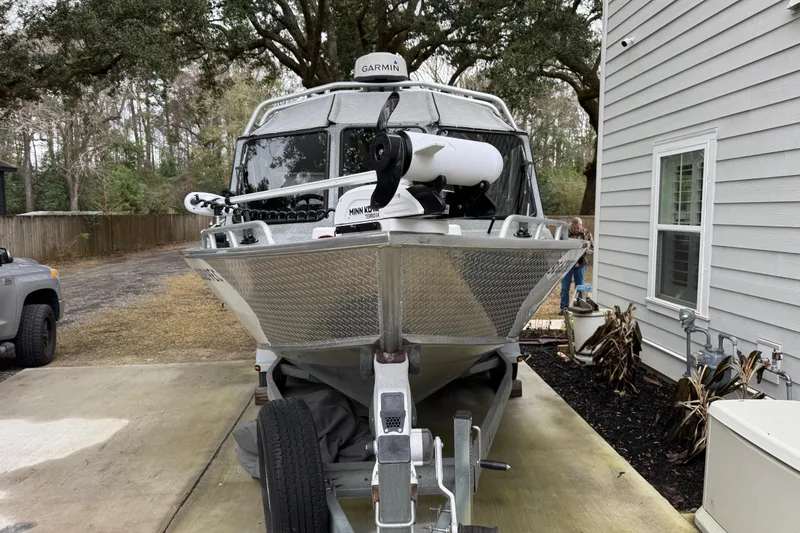 Slide: The Image of 2016 North River 21' Seahawk boat on trailer, parked beside a house. - 5