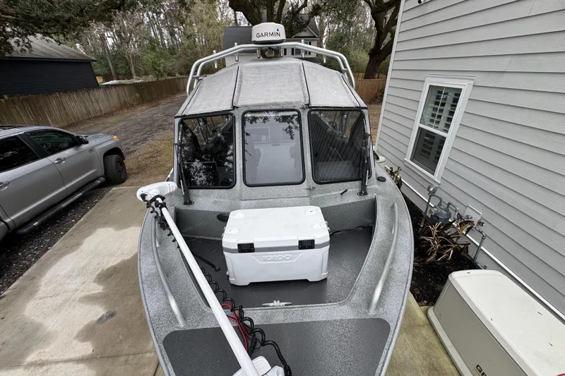 Slide: The Image of 2016 North River 21' Seahawk boat with Garmin equipment, parked beside a house. - 7