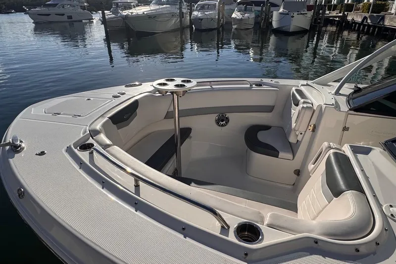 Slide: The Image of 2021 Robalo R317 Dual Console boat interior with seating and cup holders at marina. - 11