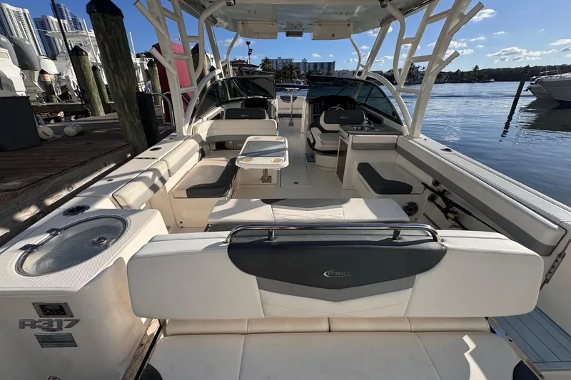 Slide: The Image of 2021 Robalo R317 Dual Console boat interior with seating and water view. - 13