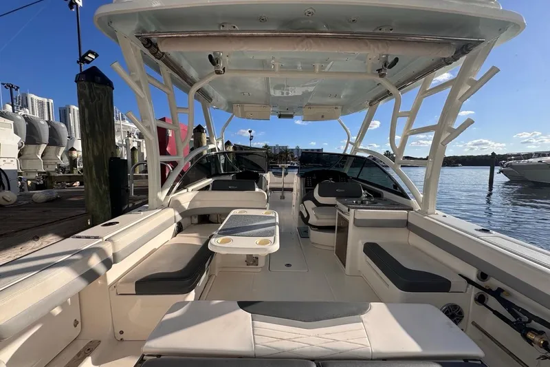 Slide: The Image of 2021 Robalo R317 Dual Console boat interior, docked with seating and helm view. - 19