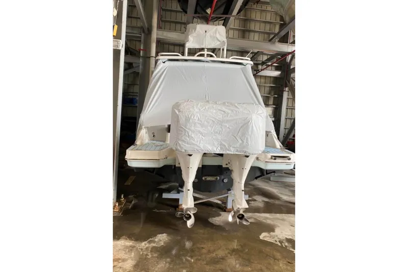 Slide: The Image of 2021 Robalo R317 Dual Console boat with twin outboard engines docked. - 2