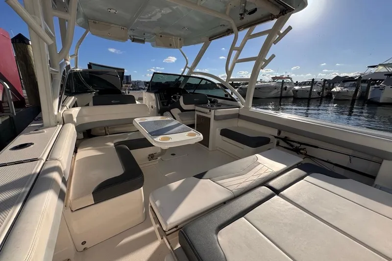 Slide: The Image of 2021 Robalo R317 Dual Console boat interior with seating and table, docked at marina. - 23