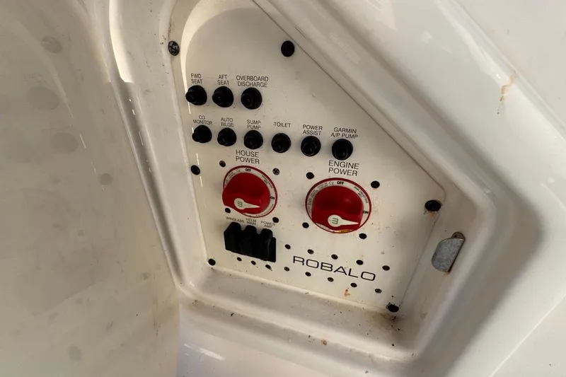 Slide: The Image of Control panel of 2021 Robalo R317 Dual Console boat with power switches and dials. - 24