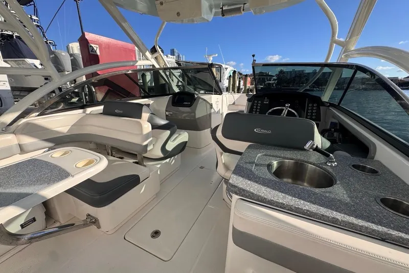 Slide: The Image of 2021 Robalo R317 Dual Console boat interior with seating, sink, and steering wheel. - 27