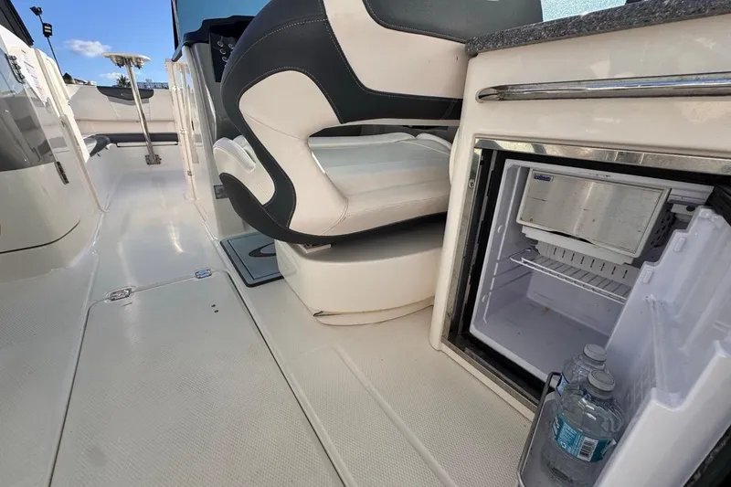 Slide: The Image of 2021 Robalo R317 Dual Console interior with open mini fridge and seating. - 29