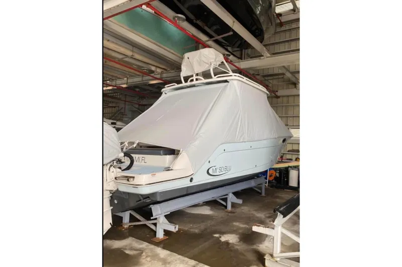 Slide: The Image of 2021 Robalo R317 Dual Console boat docked with twin 300 V6 engines. - 3