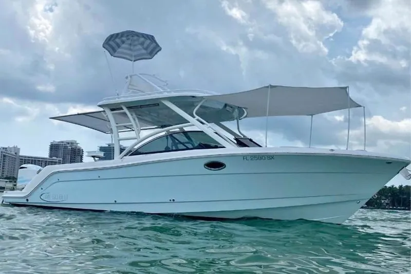 Slide: The Image of 2021 Robalo R317 Dual Console boat docked at marina under clear blue sky. - 4