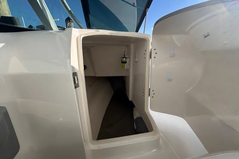 Slide: The Image of 2021 Robalo R317 Dual Console interior storage compartment with open door. - 40