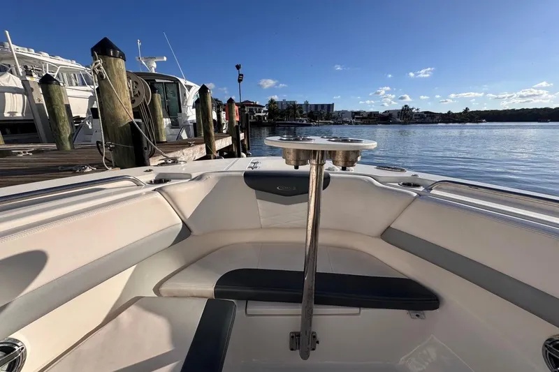 Slide: The Image of 2021 Robalo R317 Dual Console boat interior at marina, sunny day, calm water. - 44