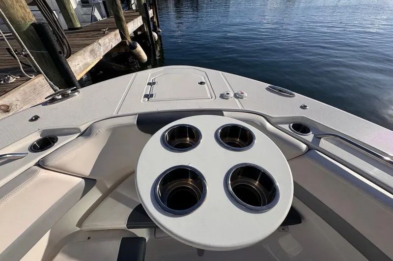 Slide: The Image of 2021 Robalo R317 Dual Console boat interior with cup holders, docked by the water. - 45