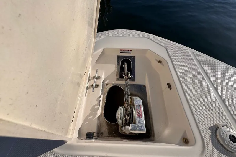 Slide: The Image of 2021 Robalo R317 Dual Console anchor compartment with chain and winch. - 46