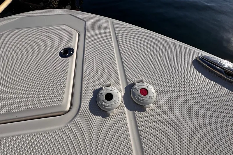 Slide: The Image of 2021 Robalo R317 Dual Console boat deck with hatch and fuel caps. - 47