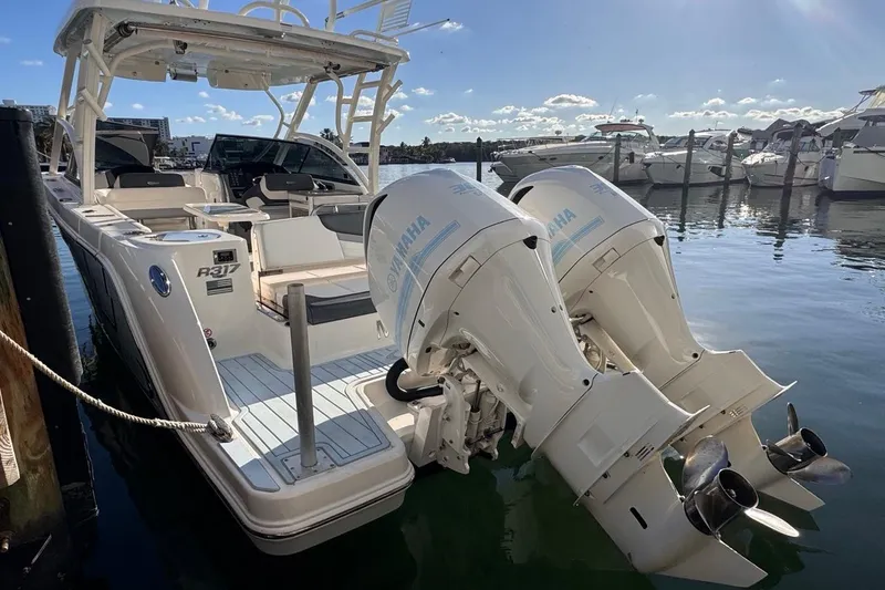 Slide: The Image of 2021 Robalo R317 Dual Console boat with twin Yamaha outboard engines docked at marina. - 5
