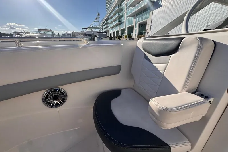 Slide: The Image of 2021 Robalo R317 Dual Console boat interior with cushioned seating and speaker. - 50