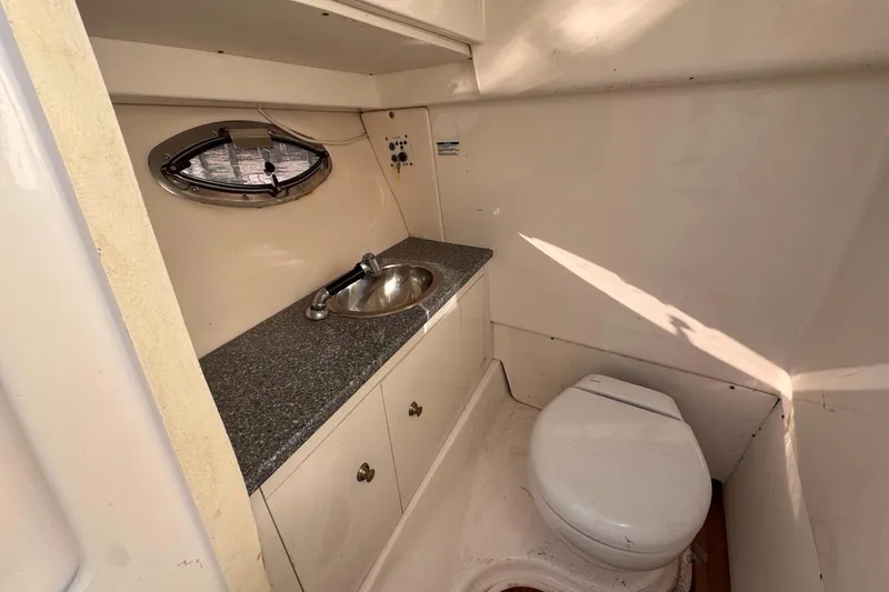 Slide: The Image of 2021 Robalo R317 Dual Console boat bathroom with sink and toilet. - 52