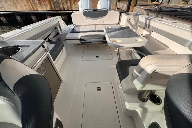 Slide: The Image of 2021 Robalo R317 Dual Console boat interior with seating and table setup. - 55