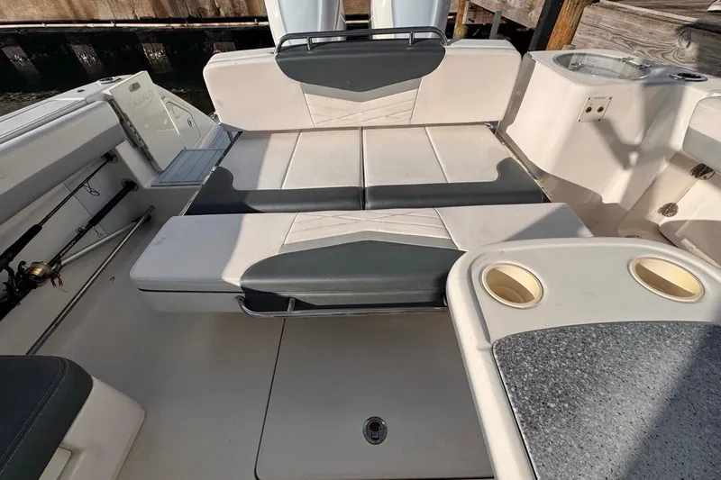 Slide: The Image of 2021 Robalo R317 Dual Console boat interior with seating and cup holders. - 56