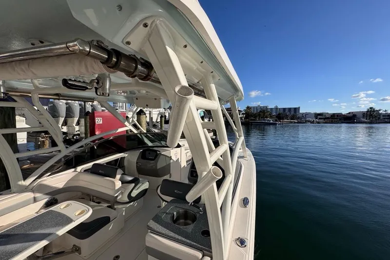 Slide: The Image of 2021 Robalo R317 Dual Console boat docked by calm waters under clear blue sky. - 58