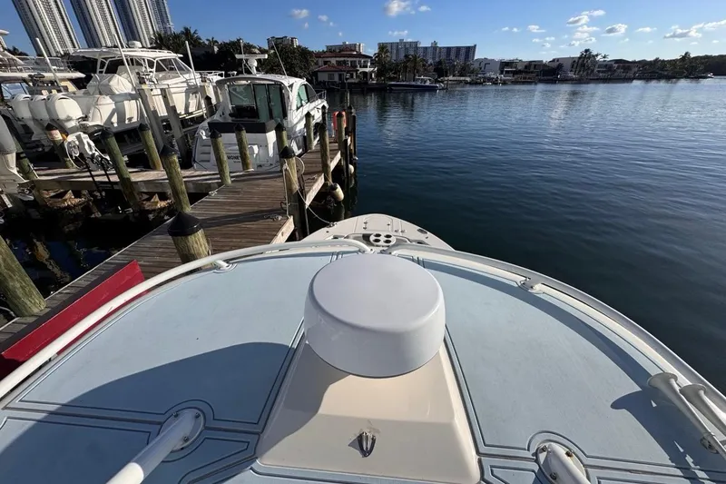 Slide: The Image of 2021 Robalo R317 Dual Console docked at marina, calm water, clear sky. - 59