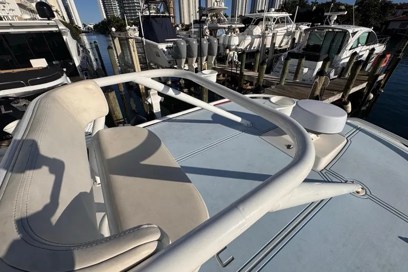 Slide: The Image of 2021 Robalo R317 Dual Console boat docked at marina with cityscape background. - 63