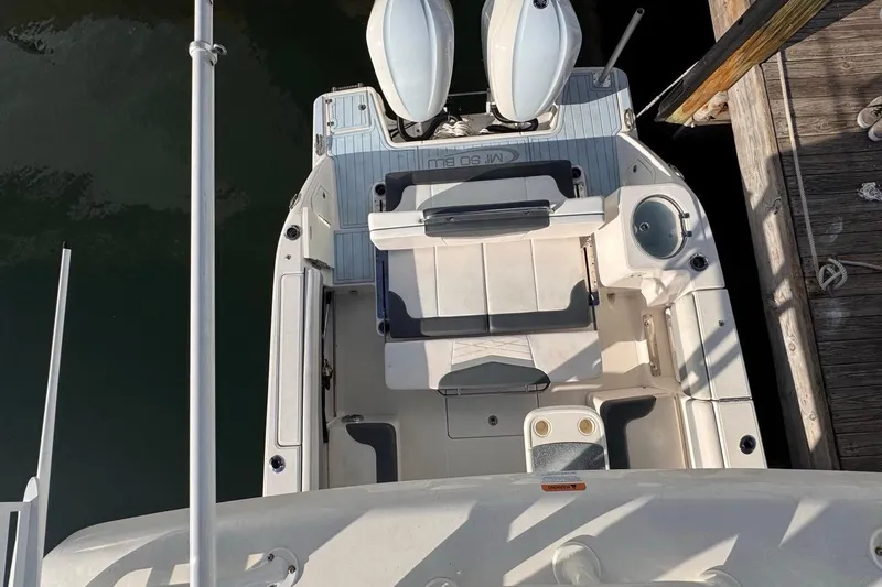 Slide: The Image of 2021 Robalo R317 Dual Console boat docked, aerial view of seating and deck area. - 65