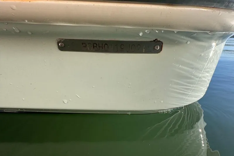Slide: The Image of 2021 Robalo R317 Dual Console boat hull with identification plate in water. - 67