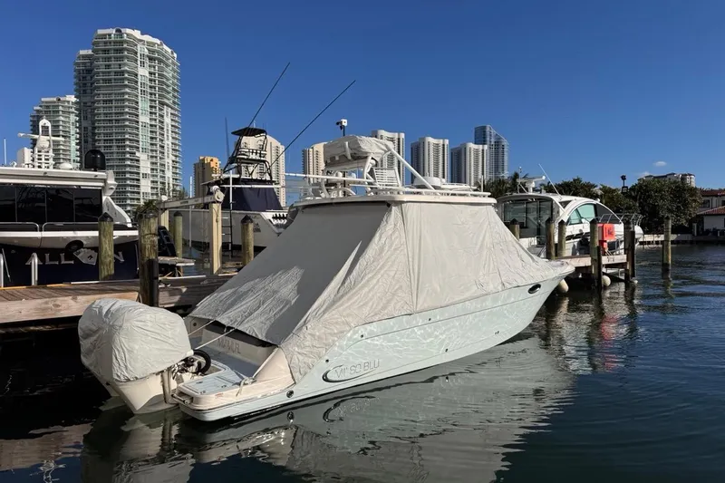 Slide: The Image of 2021 Robalo R317 Dual Console boat covered at marina with city skyline. - 72
