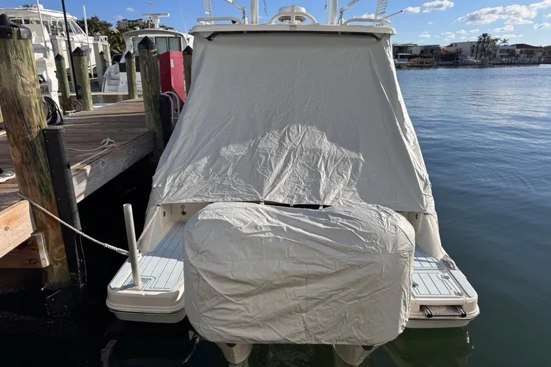 Slide: The Image of 2021 Robalo R317 Dual Console boat covered at dockside, sunny day. - 73