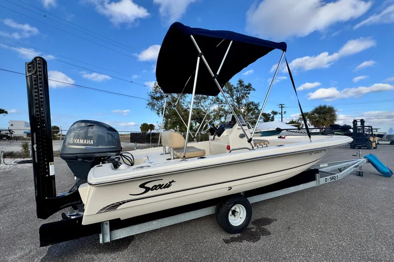 Slide: The Image of 2023 Scout 177 Sport boat with Yamaha engine on trailer, under blue sky. - 1