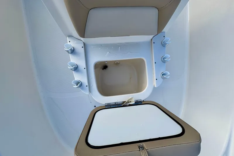 Slide: The Image of 2023 Scout 177 Sport boat interior with storage compartment and rod holders. - 13