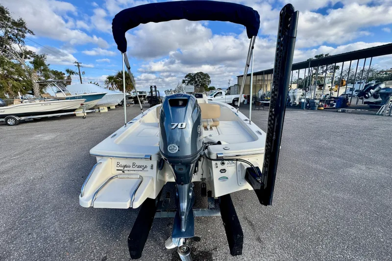 Slide: The Image of 2023 Scout 177 Sport boat with Yamaha 70 engine, parked outdoors under blue sky. - 4