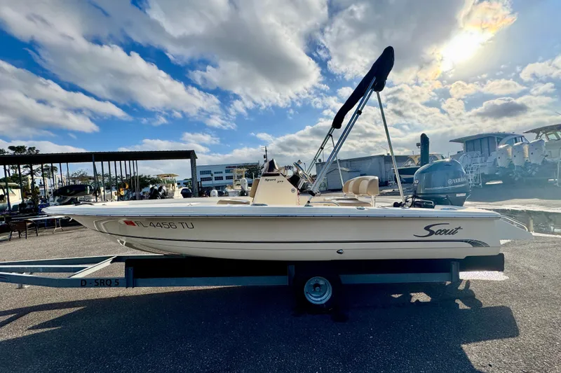 Slide: The Image of 2023 Scout 177 Sport boat on trailer under a partly cloudy sky. - 5
