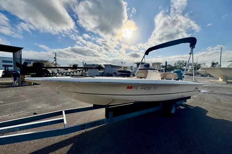 Slide: The Image of 2023 Scout 177 Sport boat on trailer under a sunny sky. - 6