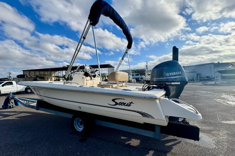 Slide: The Image of 2023 Scout 177 Sport boat with Yamaha engine on trailer under blue sky. - 7