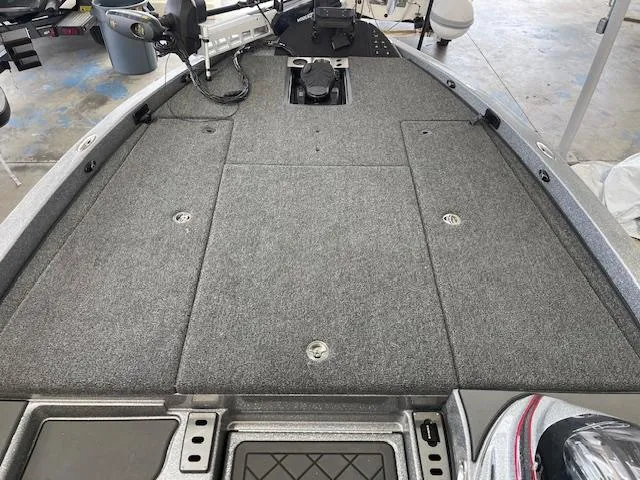 Slide: The Image of 2024 Caymas CX 20 boat deck with gray carpet and storage. - 10
