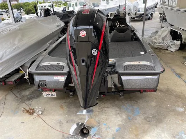 Slide: The Image of 2024 Caymas CX 20 boat with outboard motor, parked on a trailer. - 3