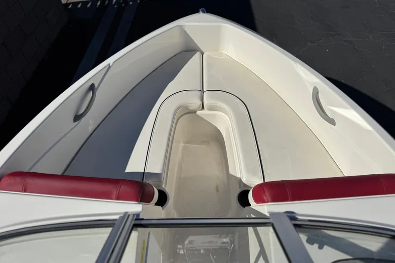 Slide: The Image of 2015 Bayliner 175 Bowrider boat interior with red seats and white deck. - 10