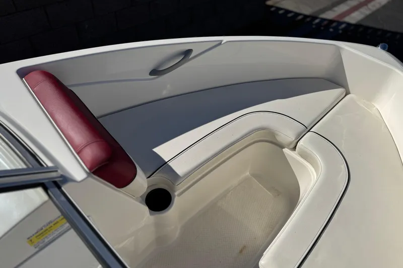 Slide: The Image of 2015 Bayliner 175 Bowrider interior with white seating and red cushion detail. - 11