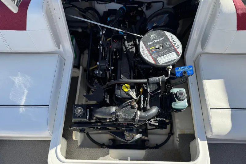 Slide: The Image of 2015 Bayliner 175 Bowrider engine compartment with MerCruiser engine visible. - 15