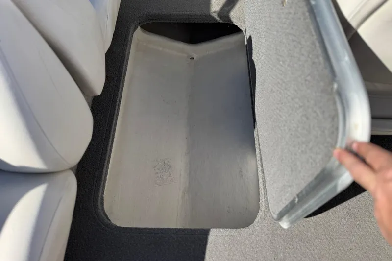 Slide: The Image of Open storage compartment in 2015 Bayliner 175 Bowrider boat interior. - 19
