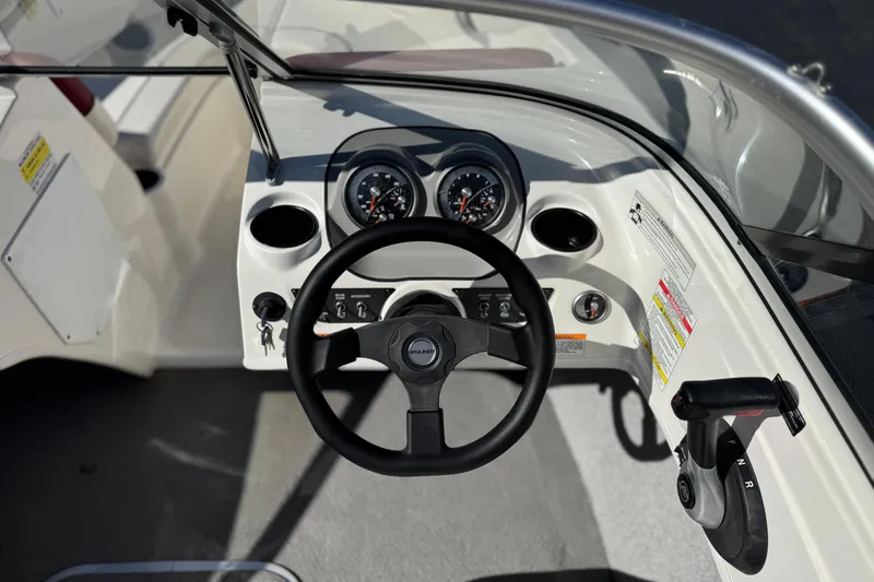 Slide: The Image of 2015 Bayliner 175 Bowrider dashboard with steering wheel and controls. - 21