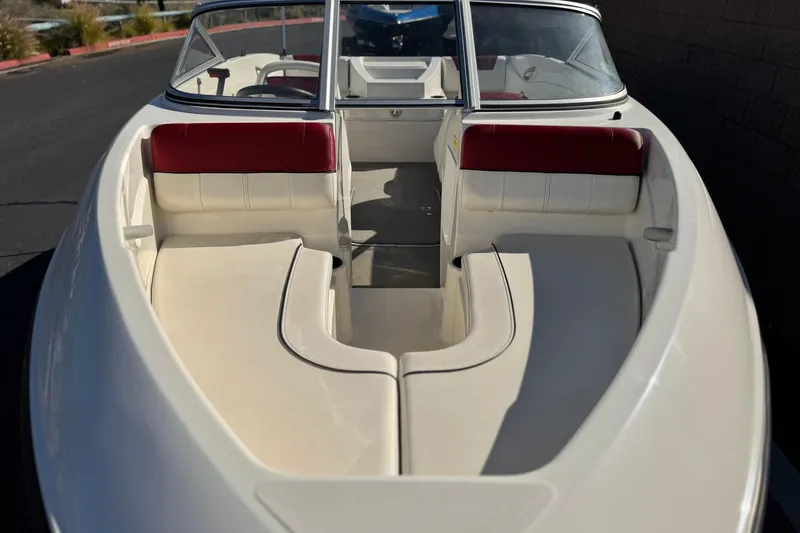 Slide: The Image of 2015 Bayliner 175 Bowrider boat interior with red and white seating. - 9