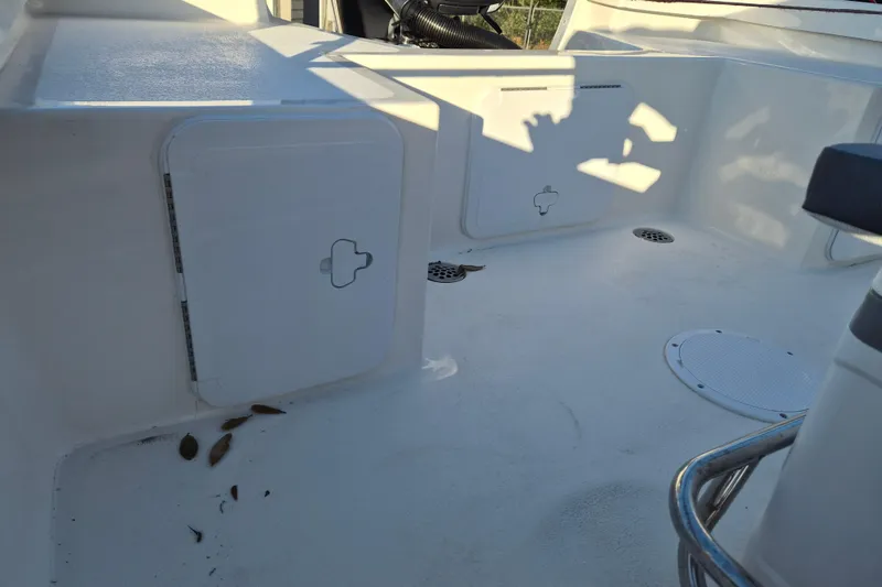 Slide: The Image of 2026 May-Craft 192 boat interior with storage compartments and clean white deck. - 10